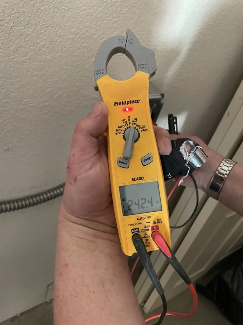 Voltage testing with clamp meter during Outlet Installation in Howell